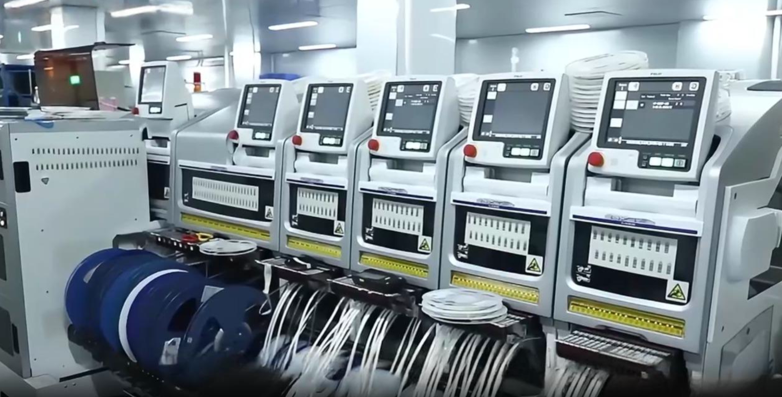 Row of SMT pick-and-place machines in the woCyber electronics facility